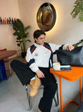 DAXUEN color-blocked track jacket with crest logo — model photo