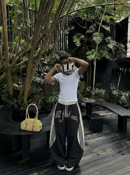 DAXUEN Color-blocked wide-leg track pants — model photo