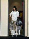 DAXUEN Embroidered short-sleeved t-shirt with colorful buttons — model photo