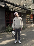DAXUEN beige and black contrast panel bomber jacket — model photo