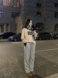 DAXUEN light beige oversized bold graphic t-shirt — model photo