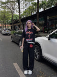 DAXUEN black oversized cracked-number trophy graphic tee — model photo