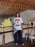 DAXUEN black oversized cracked-number trophy graphic tee — model photo