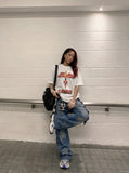DAXUEN black oversized cracked-number trophy graphic tee — model photo