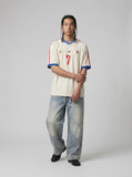 DAXUEN light blue distressed wide-leg denim jeans with cream ribbed waistband — model photo