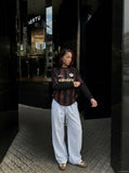 DAXUEN brown wide-leg trousers with vertical stripes and wooden bead details — model photo