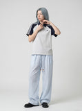 DAXUEN brown wide-leg trousers with vertical stripes and wooden bead details — model photo