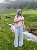 DAXUEN brown wide-leg trousers with vertical stripes and wooden bead details — model photo