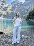 DAXUEN brown wide-leg trousers with vertical stripes and wooden bead details — model photo