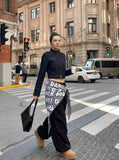 DAXUEN Cropped indigo denim jacket with gold-toned details — model photo