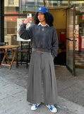 DAXUEN Cropped wide-leg trousers in medium-grey with decorative studs — model photo