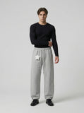 DAXUEN Wide leg sweatpants with cross print and script embroidery — model photo