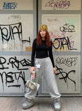 DAXUEN Wide leg sweatpants with cross print and script embroidery — model photo