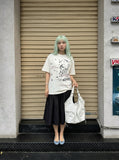 DAXUEN White short-sleeved t-shirt with abstract graphic — model photo
