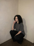 DAXUEN solid grey oversized curved-hem tee — model photo