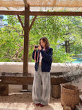 DAXUEN faded grey oversized curved-panel denim pants — model photo