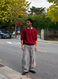 DAXUEN faded grey oversized curved-panel denim pants — model photo