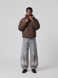 DAXUEN faded grey oversized curved-panel denim pants — model photo