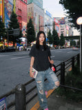 DAXUEN washed black oversized curved-seam emblem tee — model photo