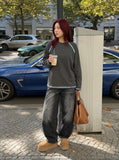 DAXUEN washed black wide-leg denim jeans with curved seams — model photo