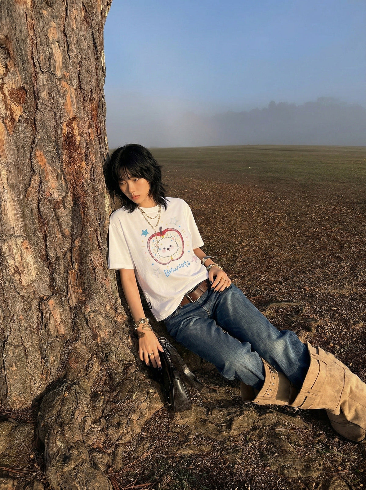 DAXUEN Graphic t-shirt featuring an apple and bear design — model photo