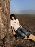 DAXUEN Graphic t-shirt featuring an apple and bear design — model photo
