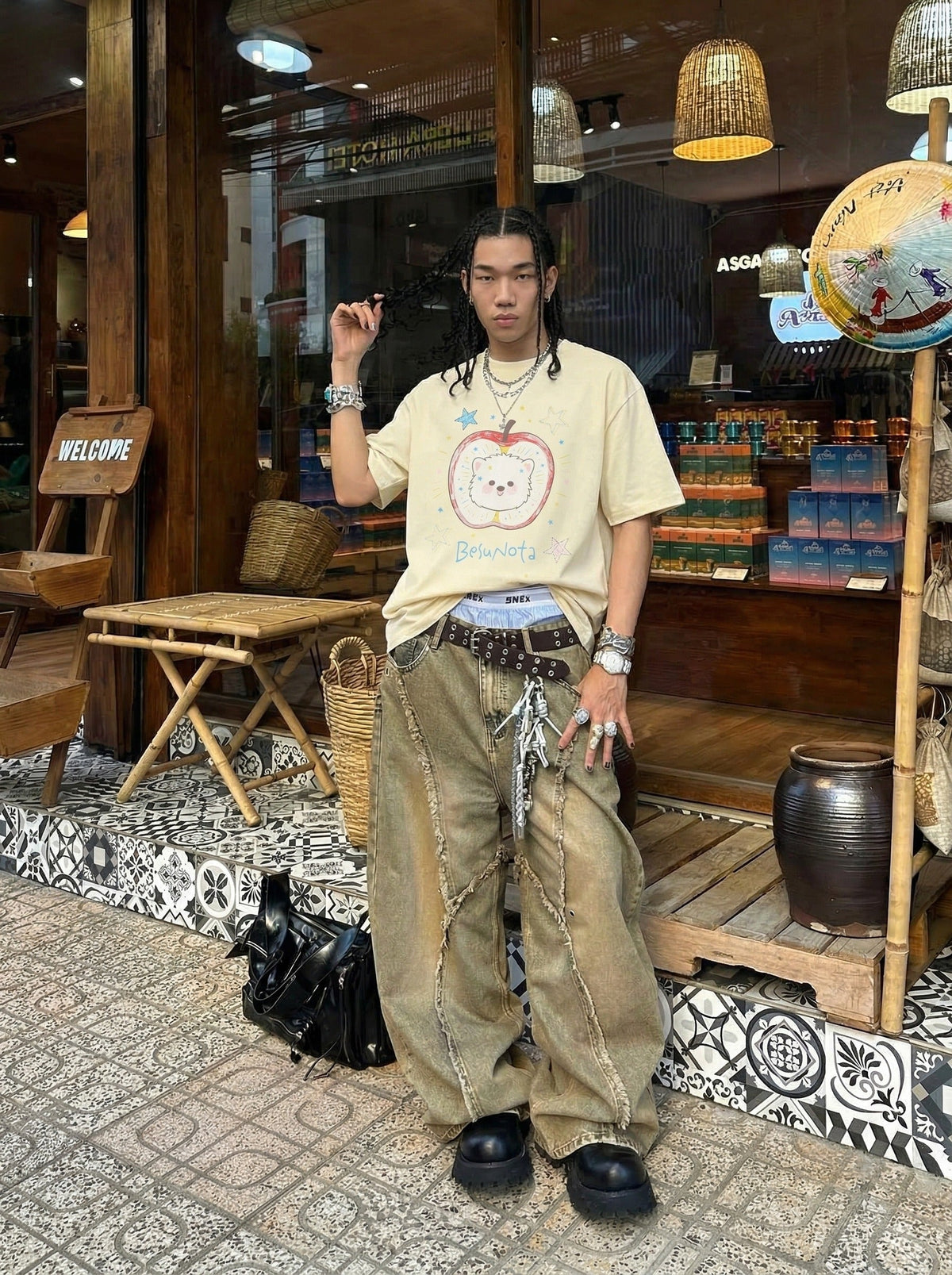 DAXUEN Graphic t-shirt featuring an apple and bear design — model photo