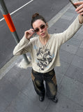 DAXUEN heathered light beige botanical print knit top — model photo