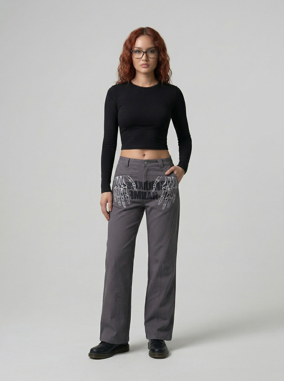 DAXUEN Dark grey women's flared pants with graphic details — model photo
