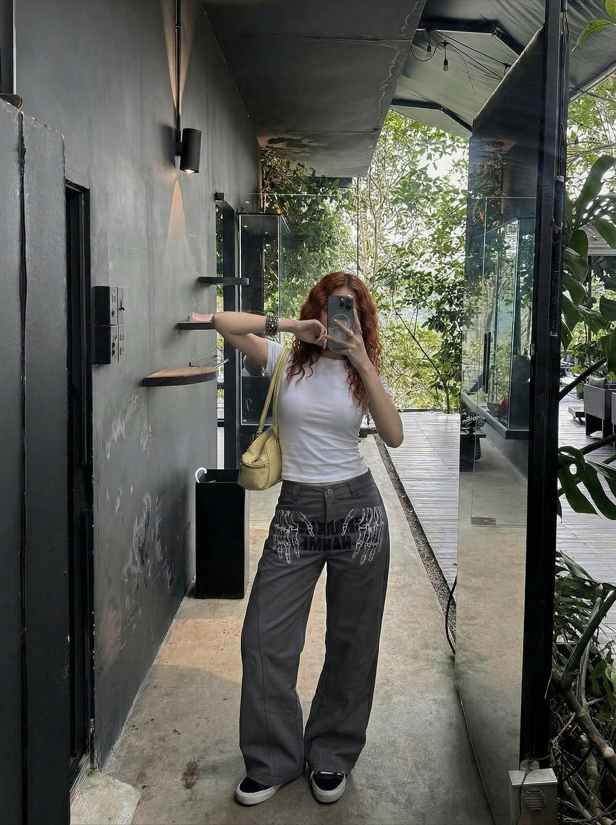DAXUEN Dark grey women's flared pants with graphic details — model photo