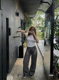 DAXUEN Dark grey women's flared pants with graphic details — model photo
