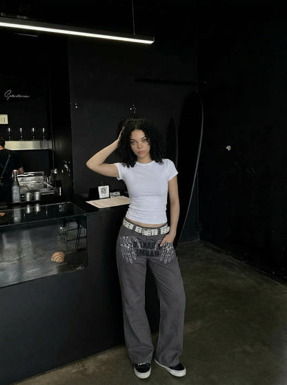 DAXUEN Dark grey women's flared pants with graphic details — model photo
