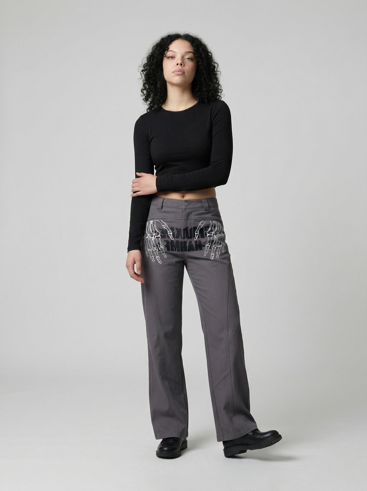 DAXUEN Dark grey women's flared pants with graphic details — model photo
