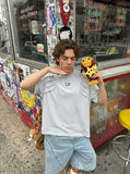 DAXUEN Distinctive short-sleeved T-shirt with emblem and pleated panels — model photo
