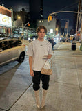 DAXUEN Distinctive short-sleeved T-shirt with emblem and pleated panels — model photo
