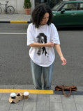 DAXUEN black oversized distorted face graphic tee — model photo