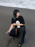DAXUEN black oversized distorted face graphic tee — model photo