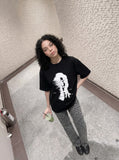 DAXUEN black oversized distorted face graphic tee — model photo