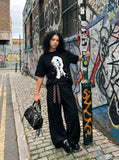 DAXUEN black oversized distorted face graphic tee — model photo