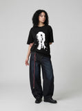 DAXUEN black oversized distorted face graphic tee — model photo