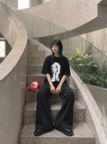 DAXUEN black oversized distorted face graphic tee — model photo