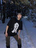 DAXUEN black oversized distorted face graphic tee — model photo