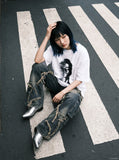 DAXUEN black oversized distorted face graphic tee — model photo