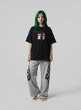 DAXUEN black oversized distressed abstract starburst graphic tee — model photo