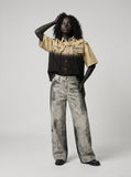DAXUEN washed grey wide-leg trousers with distressed abstract print — model photo
