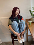 DAXUEN black oversized t-shirt with distressed alphanumeric graphic — model photo
