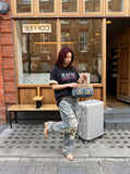 DAXUEN faded light purple oversized 'ANM' graphic tee — model photo