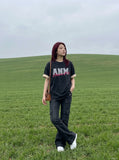 DAXUEN faded light purple oversized 'ANM' graphic tee — model photo