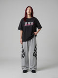 DAXUEN faded light purple oversized 'ANM' graphic tee — model photo