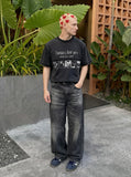 DAXUEN Black short-sleeved t-shirt with distressed text and graphics — model photo